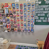 Hot Wheels diecast car blister packs on pegboard display