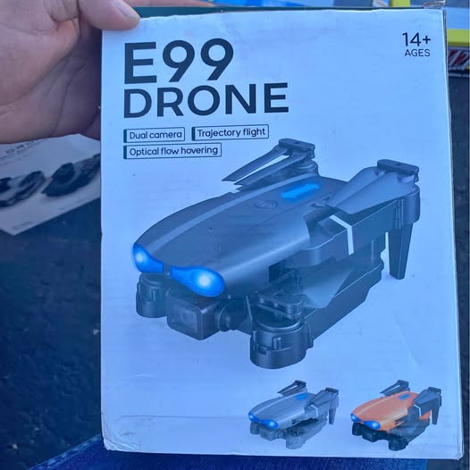 Drone E99 toy on retail box, dual camera and projector flight shown