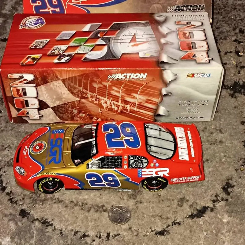 Red diecast race car with number 29 and blue/yellow side graphics, in packaging