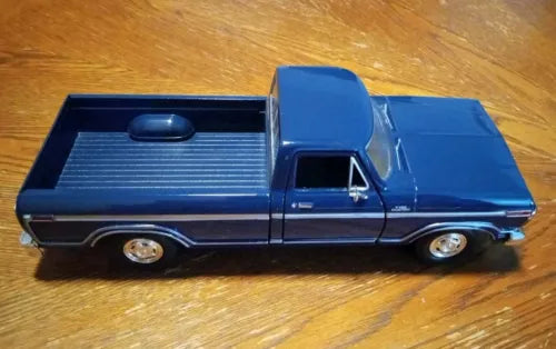 Blue diecast Ford F-150 pickup truck with black side stripes