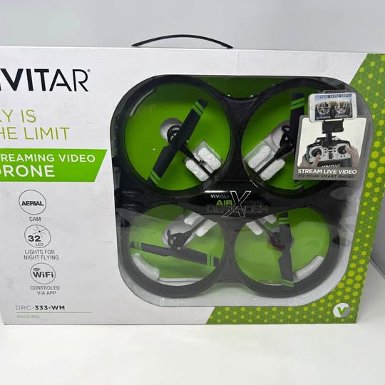 Green Vivitar quadcopter drone with camera, shown in retail box packaging