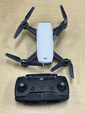 DJI Spark drone with white body and black propellers, paired with black controller