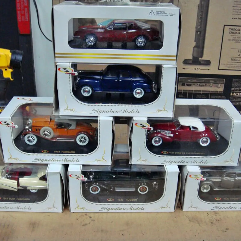 1:32 scale diecast car set in original boxes, multiple cars shown through clear windows