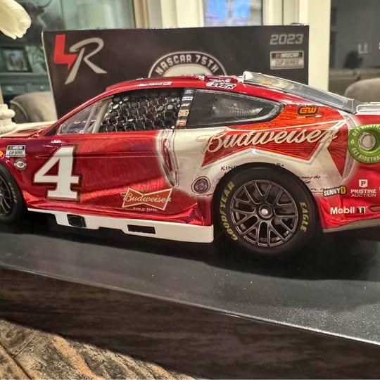 Red #4 NASCAR diecast race car with Budweiser graphics and silver side stripe