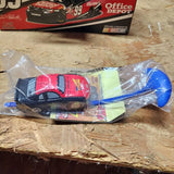 Collectible diecast race car in clear plastic bag, blue nose with red and black graphics.