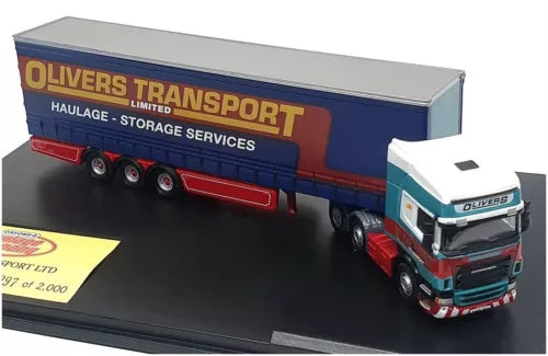 Diecast Scania truck with blue trailer, red chassis and cab, front three-quarter view