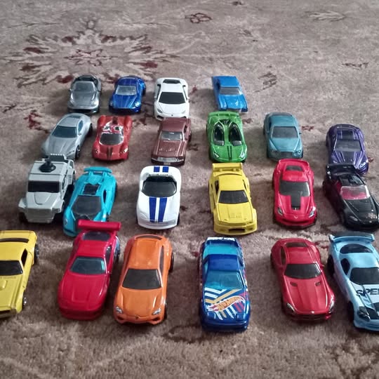 Assorted diecast toy cars, mixed colors, detailed body and wheels.