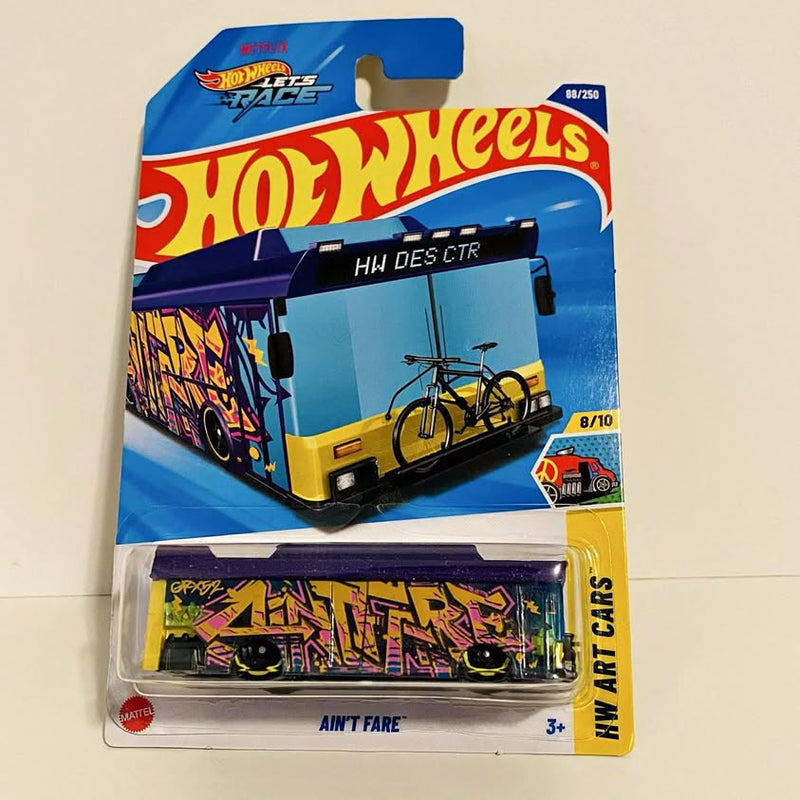 Hot Wheels diecast art car bus with purple, yellow and blue graphics in blister pack