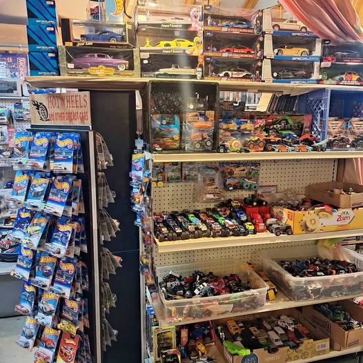 Diecast car assortment with multiple packaged cars on store display
