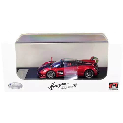 Red metallic diecast roadster model car with carbon details, in display box.
