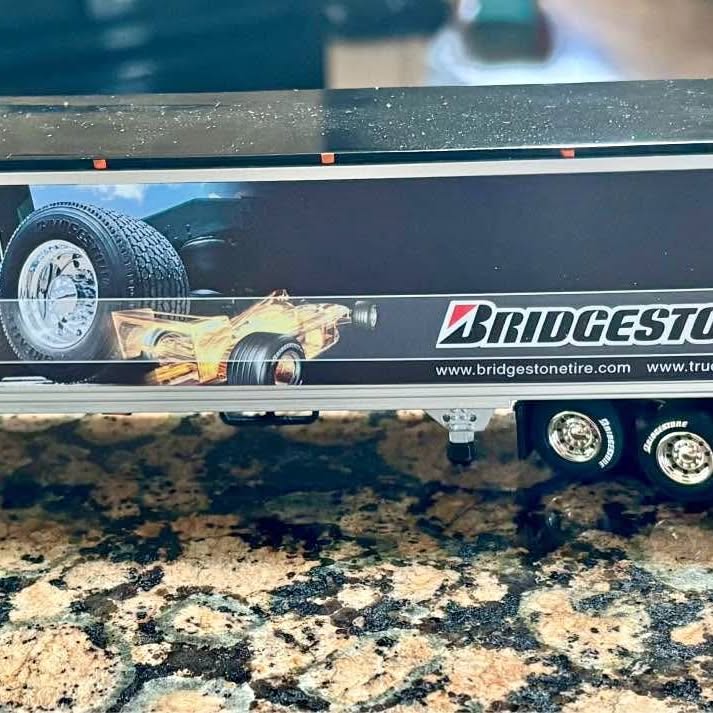 Diecast tractor trailer replica with Bridgestone logo, front wheel and side panel