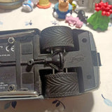 Diecast car model with open side panel and black wheels