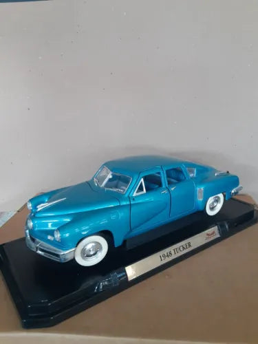 Blue 1948 Tucker torpedo diecast model car, 1:18 scale on display base