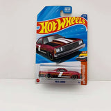 Hot Wheels 1980 El Camino diecast car in retail blister pack, red and black.