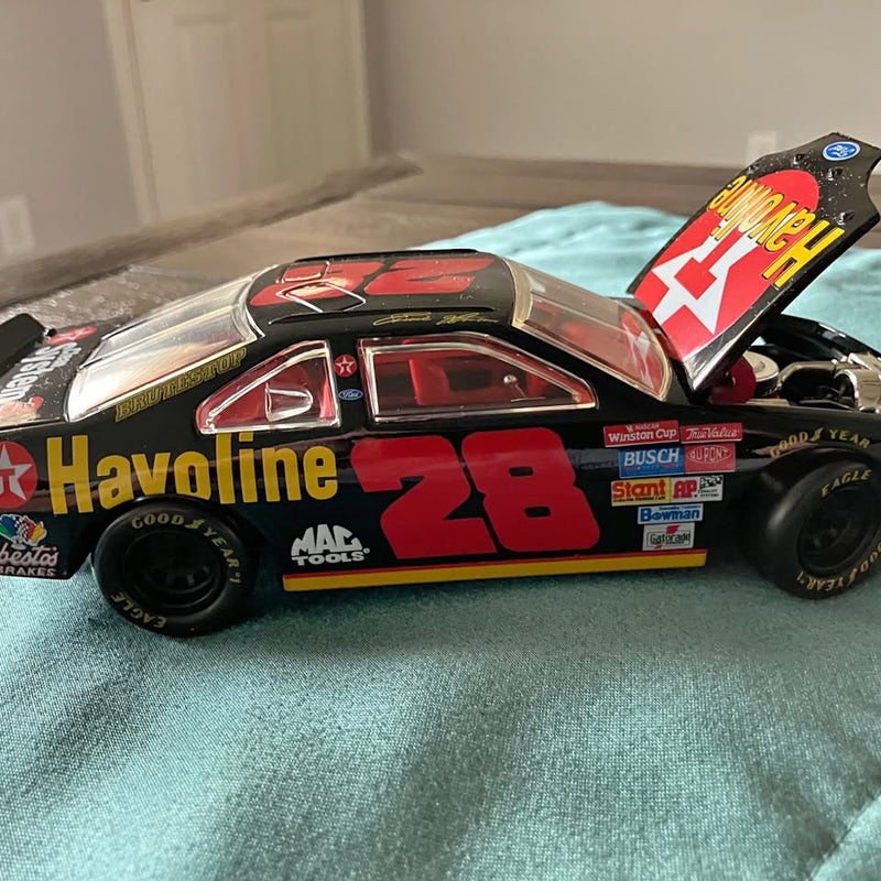 Red and black die-cast race car with #28 decals and rear wing detail