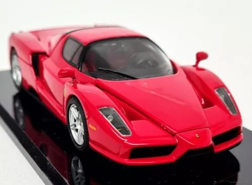 Red diecast model car, front-left view with detailed front grille and headlights