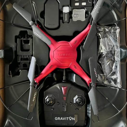 Red and black quadcopter drone with propellers and GRAVITON label
