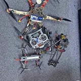 Multirotor drone with camera on top, four arms with propellers and landing legs
