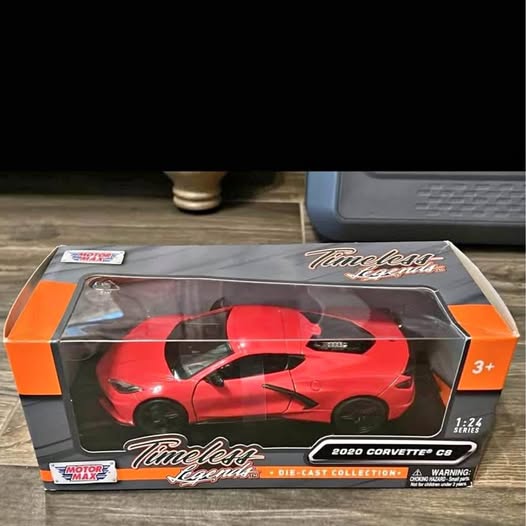 Red sports car die-cast model in retail box with clear window, 1:24 scale