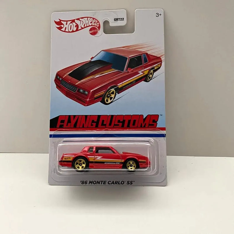 Red die-cast 1986 Monte Carlo SS car with black hood and gold wheels