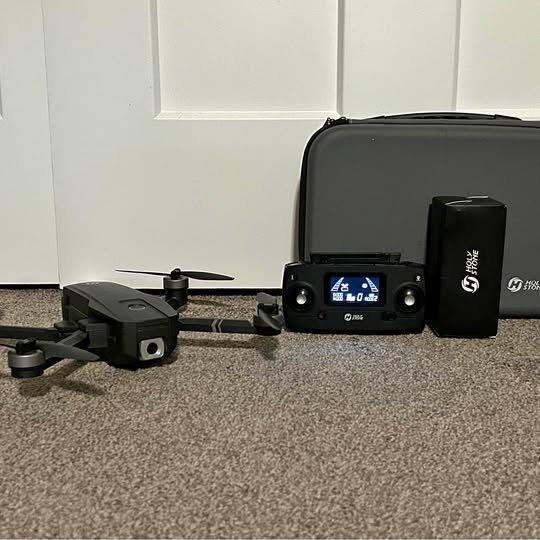 Compact black drone with remote controller and black carrying case