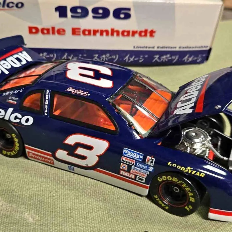 Die-cast race car model, blue with orange accents and number 3 decal