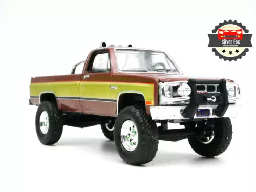 Two-tone brown and gold die-cast 1982 pickup truck with lifted tires