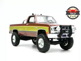 Two-tone brown and gold die-cast 1982 pickup truck with lifted tires