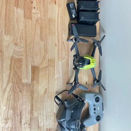 DJI FPV drone and controller, gray with green prop guards