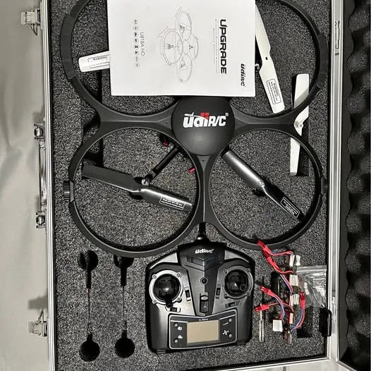 Drone quadcopter kit in hard case with remote controller and four propellers