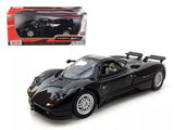 Black diecast model car with open cockpit, shown with retail box