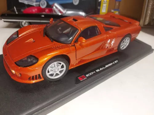 Orange 1:18 diecast sports car with black hood and side decals