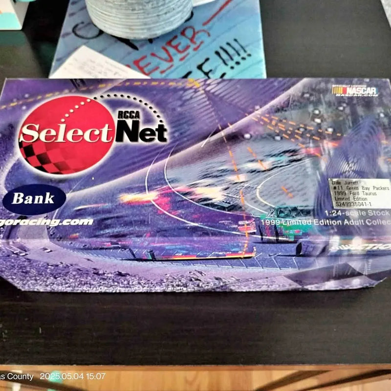 1:24 diecast racing car model in retail box, purple and red SelectNet branding