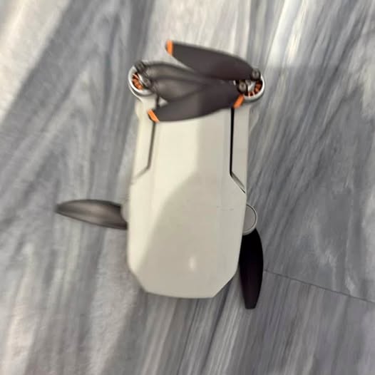 DJI Mini 2 SE drone with propellers and orange accents