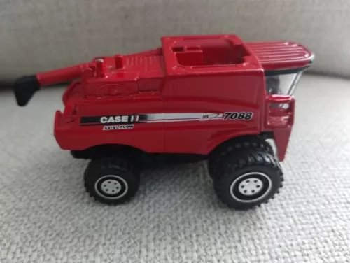 Red diecast combine harvester model with black tires and CASE IH branding