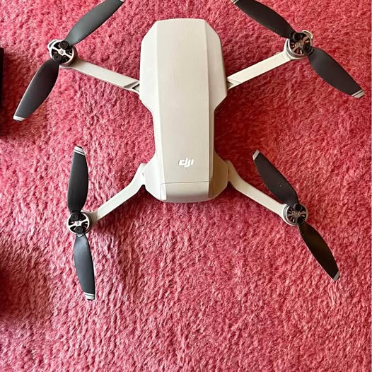 DJI Mavic Mini drone with four propellers, white body
