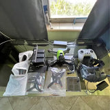 DJI FPV drone kit with controller, FPV goggles, and spare parts on display