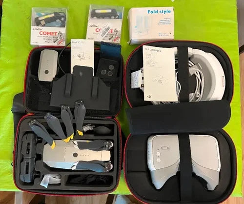 Drone accessories kit in a black case with controller and remote pieces, cables inside
