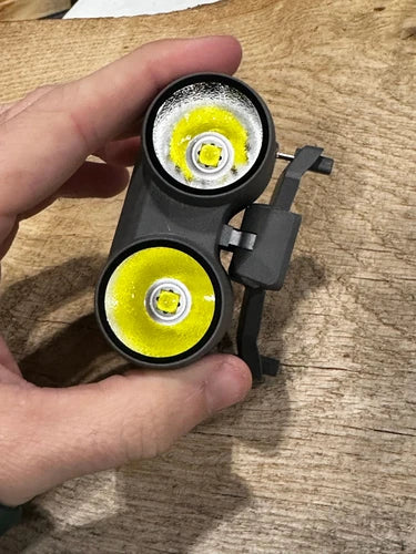 Drone spotlight light module with dual circular yellow lenses, black bracket mount