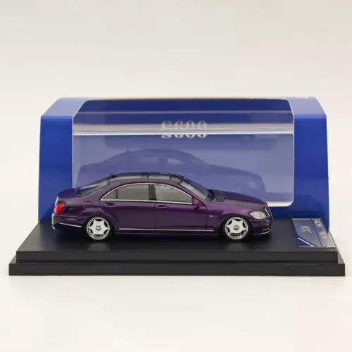 Purple diecast sedan model car in blue display case, 3/4 side view
