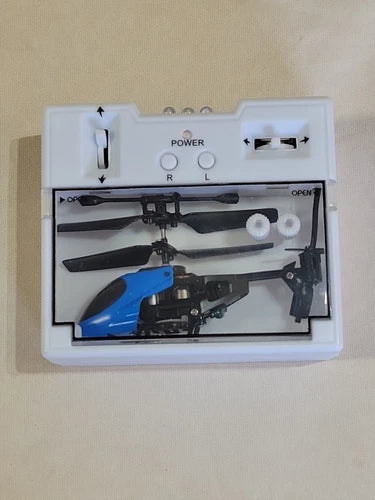 Blue and black mini RC helicopter drone with remote controls in open box