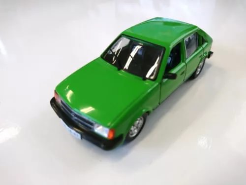 Green diecast model car with black front bumper and clear headlights