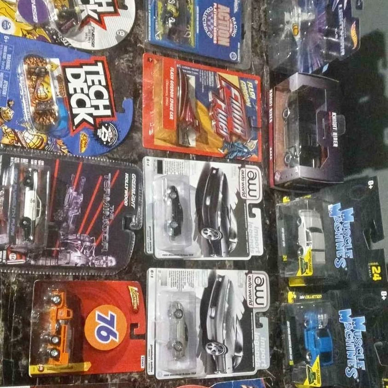 Assorted diecast cars in blister packages, various colors and designs