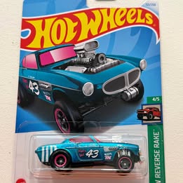 Hot Wheels diecast race car, teal vintage coupe with black hood, in blister pack