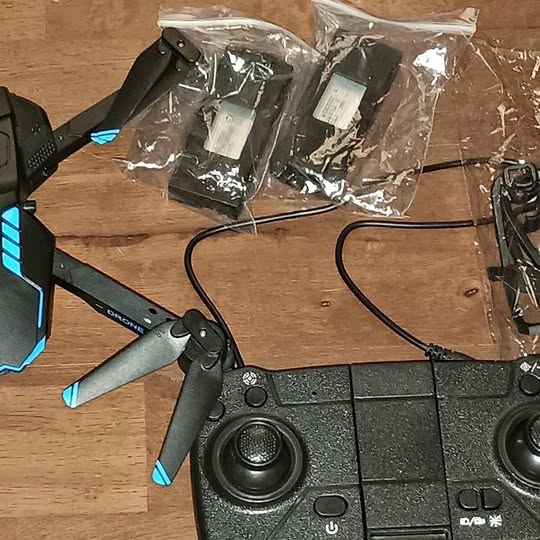 Foldable quadcopter drone with blue LED lights and four propellers