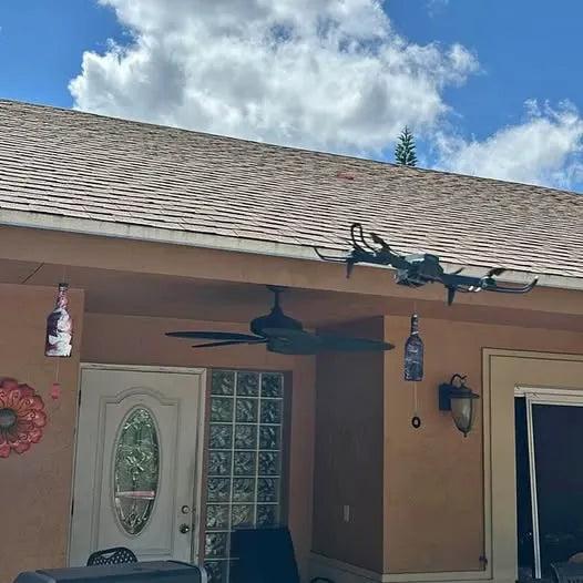 Black quadcopter drone with four propellers, hanging display