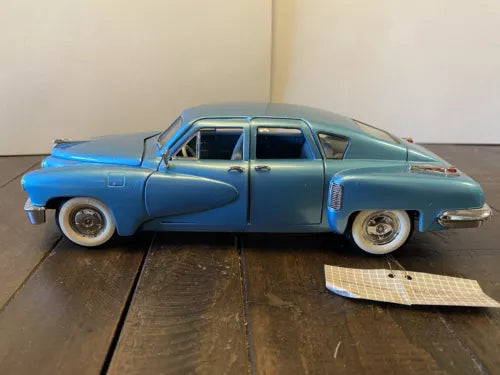 Blue 1948 Tucker Torpedo 1:24 diecast model car with chrome details, side view