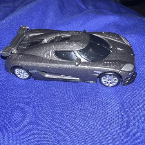 Dark gray diecast sports car with open wheels and silver rim detail