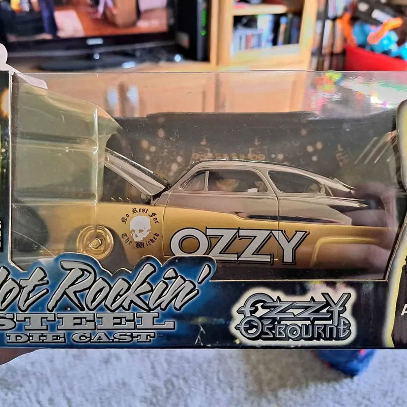 Gold and black diecast car in clear box with large OZZY logo on the side