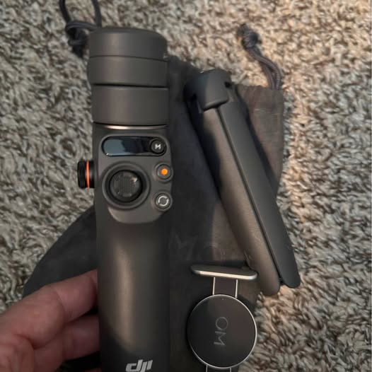 DJI drone with dark camera body, lens front, and circular gimbal module